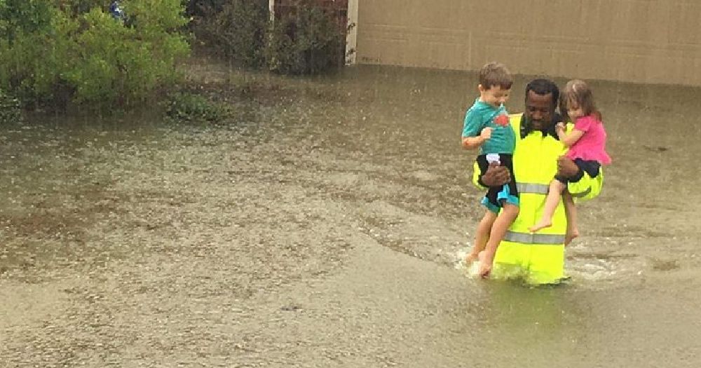 A photo of children being rescued from Harvey flooding in Houston, photo by Harris County Sheriff's Dept.